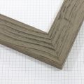 This flat grey frame features a natural wood grain texture using smooth ripples. The aged appearance of the frame has a brown wood like colouring peeking out under the grey wash. This frame uses both colour and texture to create a rustic barnwood effect.