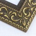 A large, reverse curve profile frame with an intricate leaf design bordered by a geometric outer edge and beaded inner lip. A dark, matte gold-brown base with gold foil patina for added depth on the topmost points of the design. Strong, solid wood construction.
3.25 " witdth: ideal for large and oversize (extra large) images.